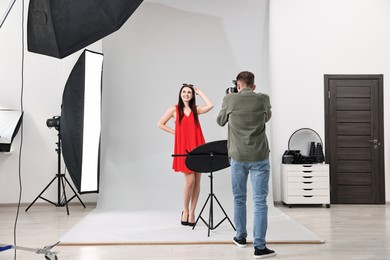 Photo of Photographer working with model in professional photo studio