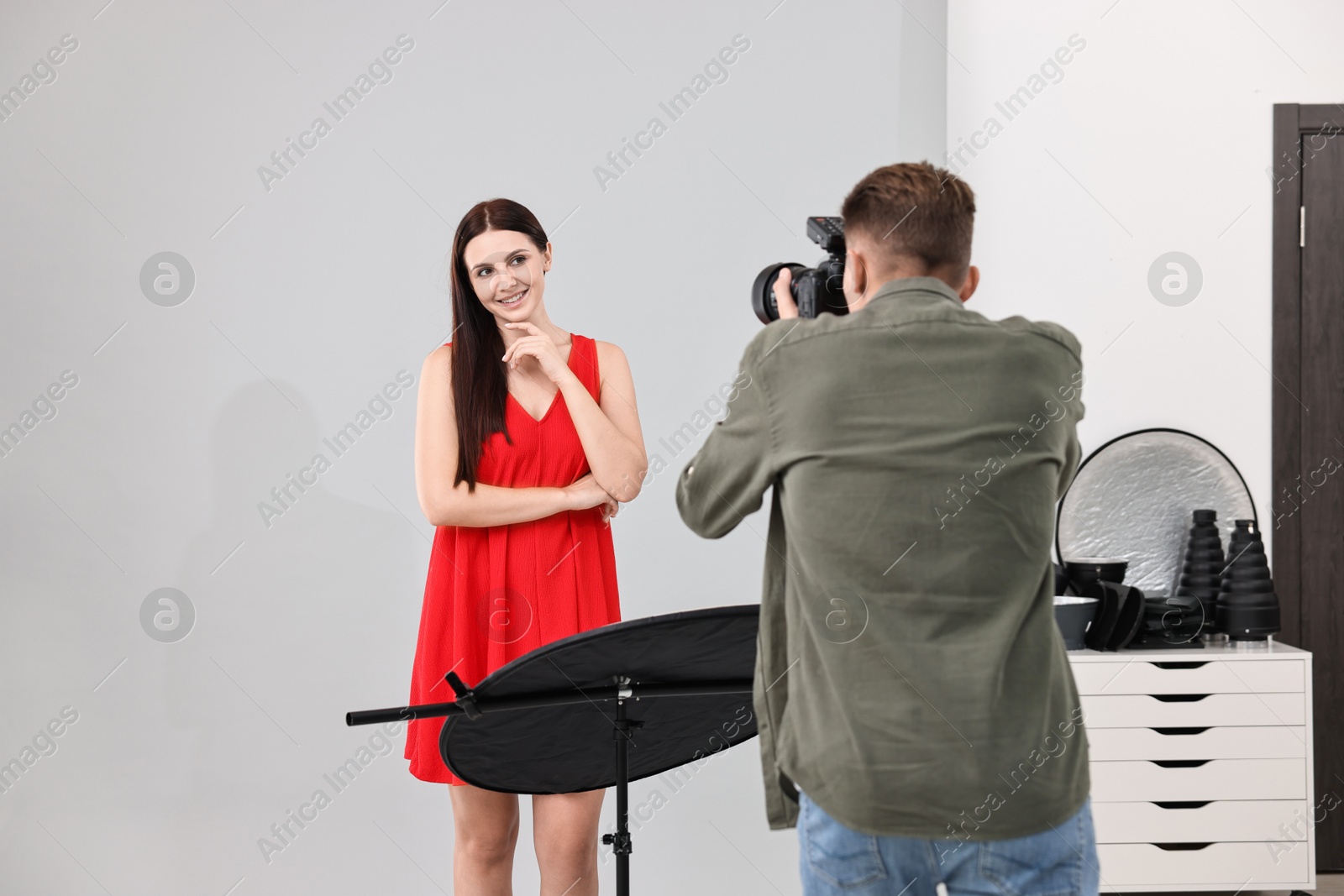 Photo of Photographer working with model in professional photo studio