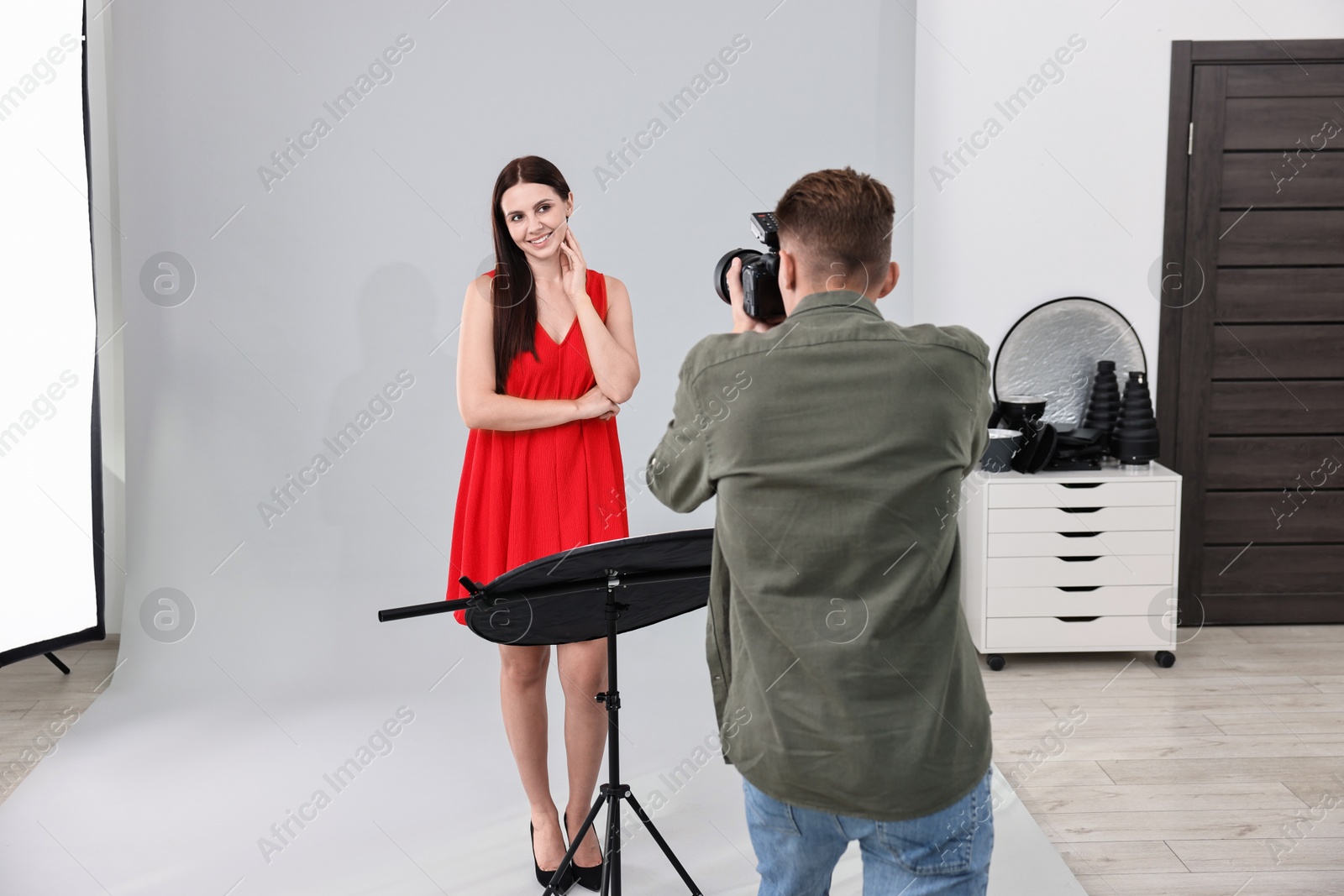 Photo of Photographer working with model in professional photo studio