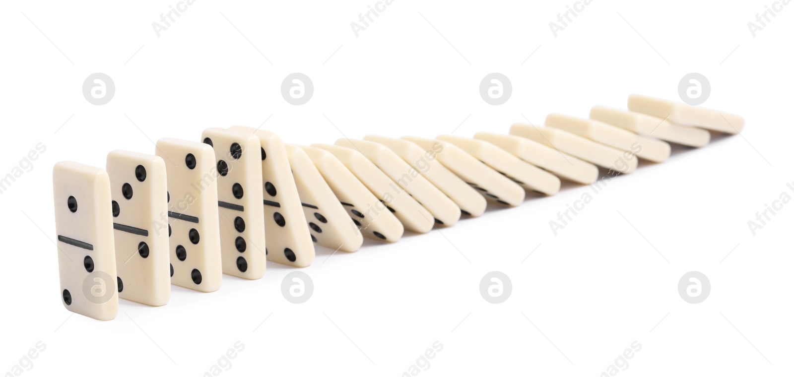 Photo of Domino effect. Tiles falling on white background