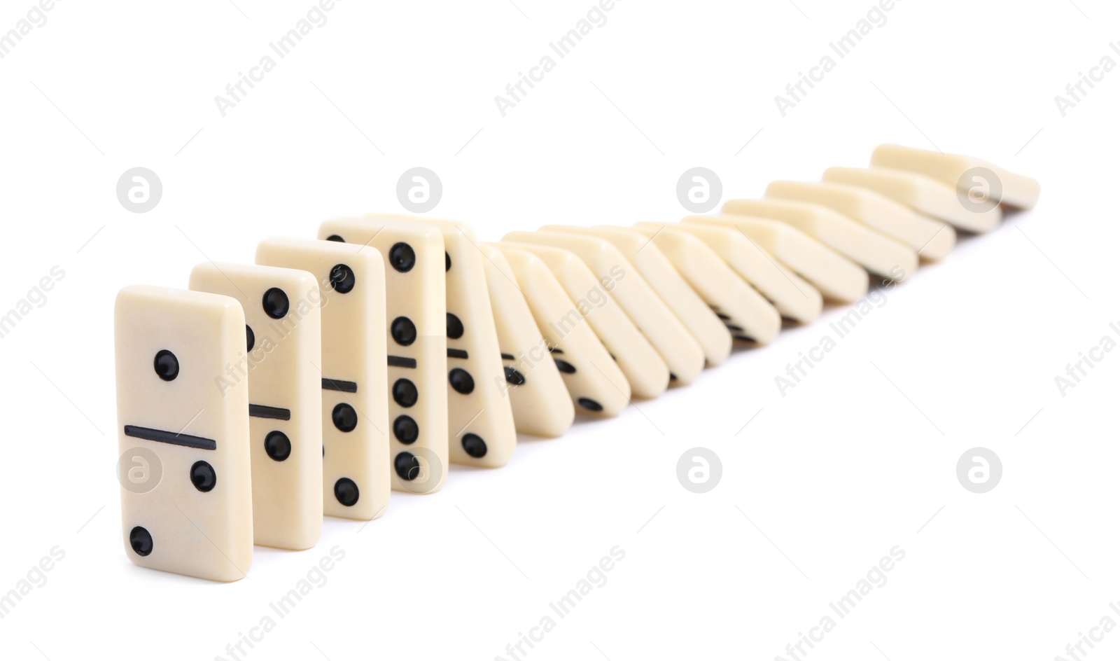 Photo of Domino effect. Tiles falling on white background