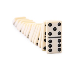 Photo of Domino effect. Tiles falling on white background