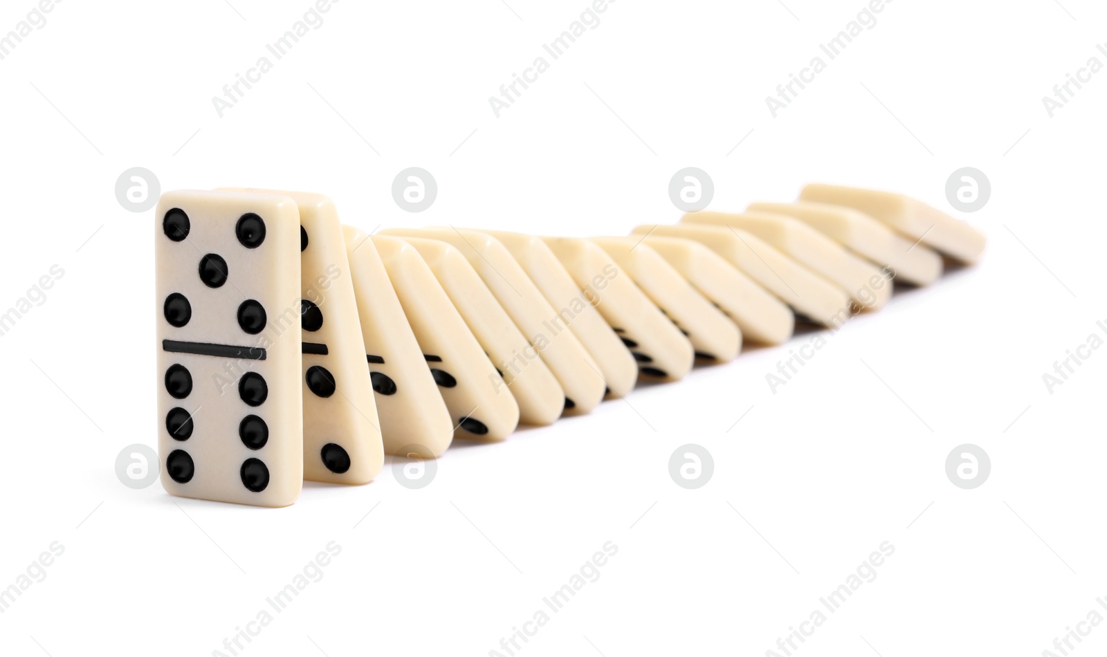 Photo of Domino effect. Tiles falling on white background