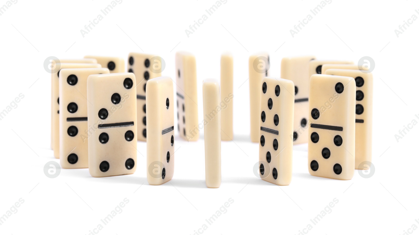 Photo of White domino tiles with black pips isolated on white