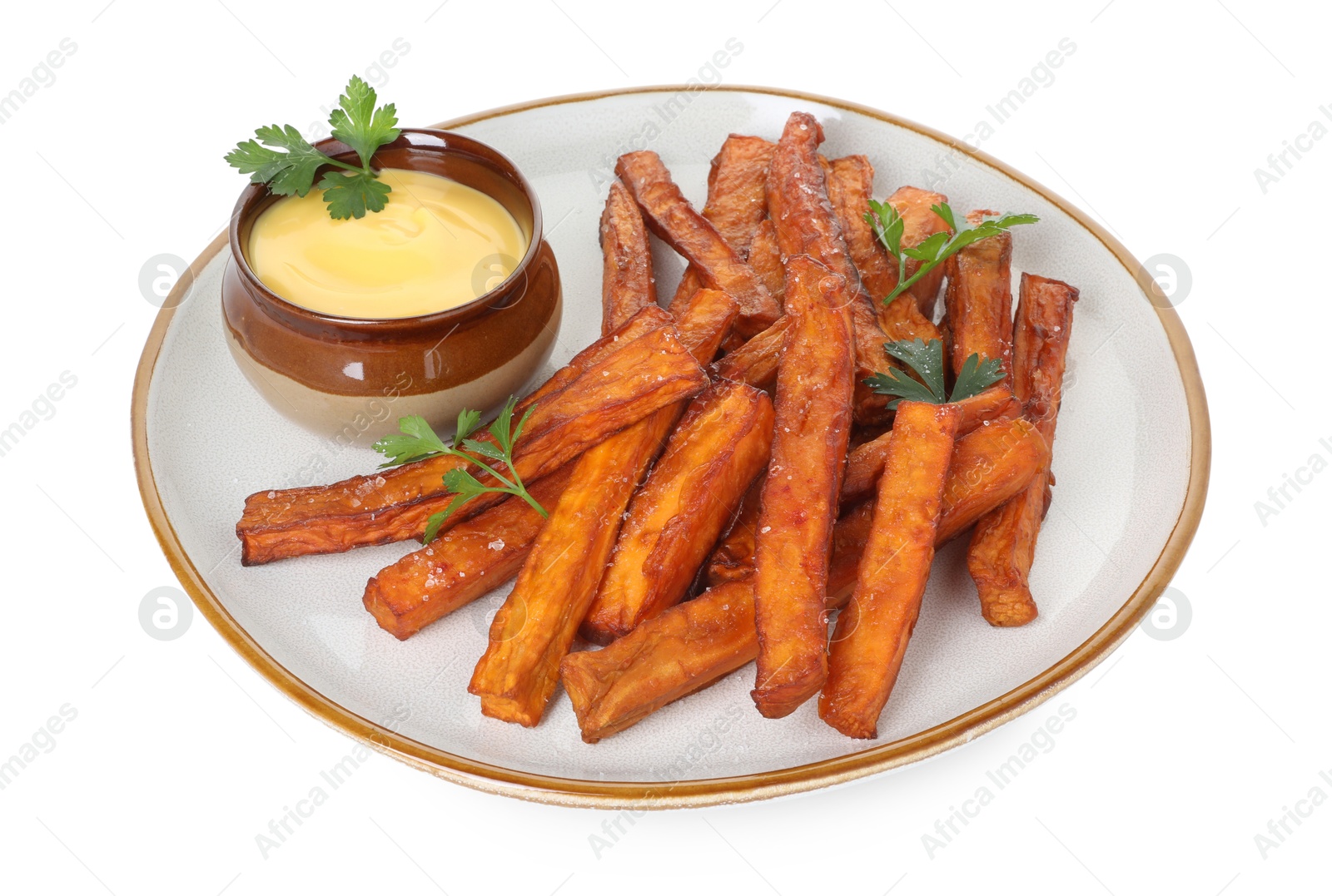 Photo of Delicious sweet potato fries, parsley and sauce isolated on white