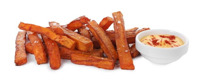 Photo of Delicious sweet potato fries and sauce isolated on white