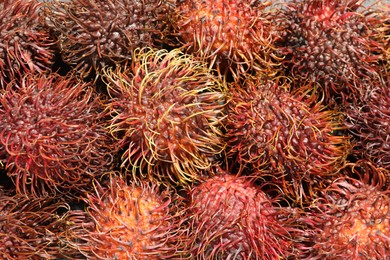 Photo of Pile of fresh rambutans as background, closeup