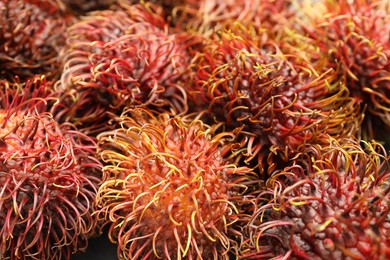 Photo of Pile of fresh rambutans as background, closeup