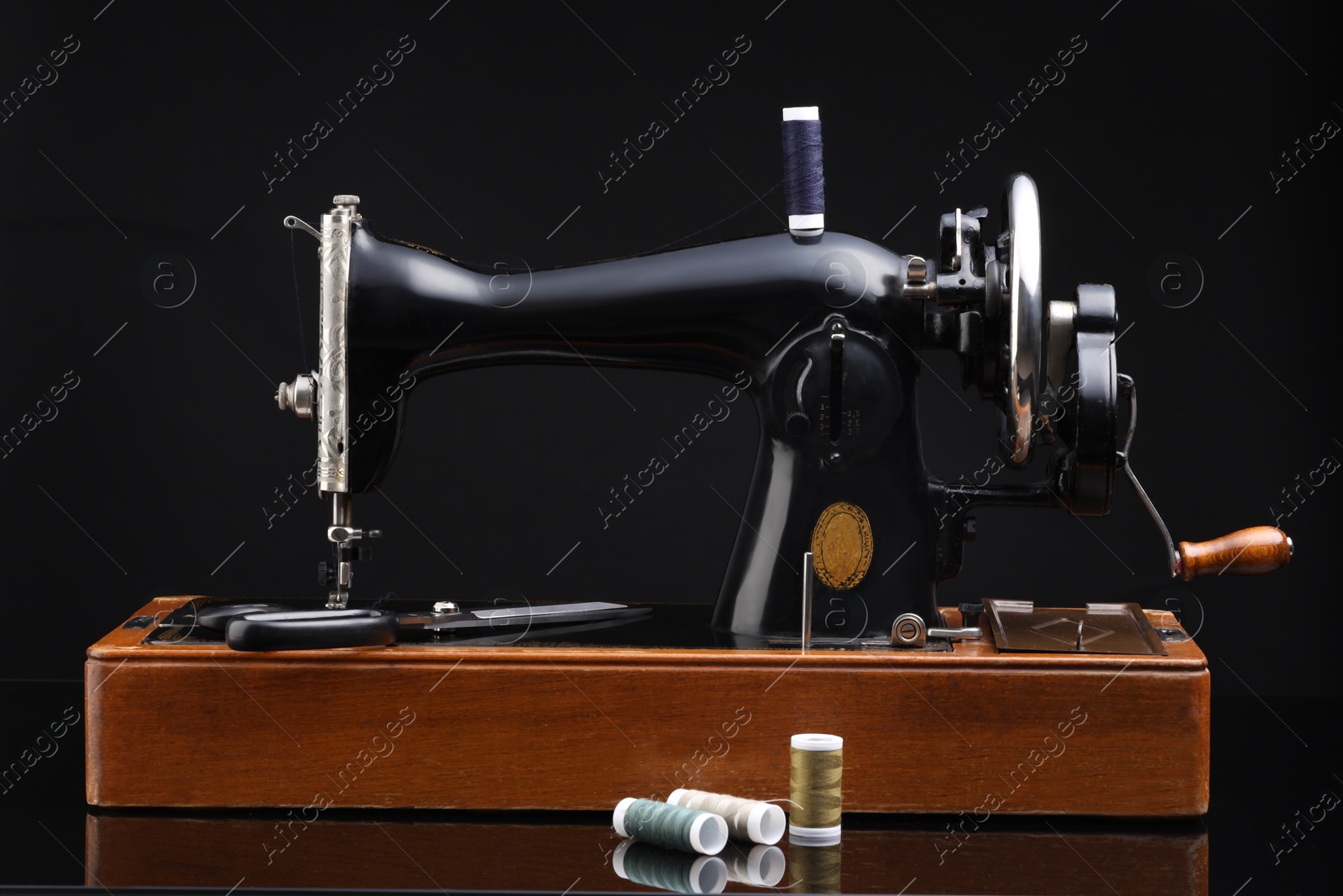 Photo of Vintage professional sewing machine on black background