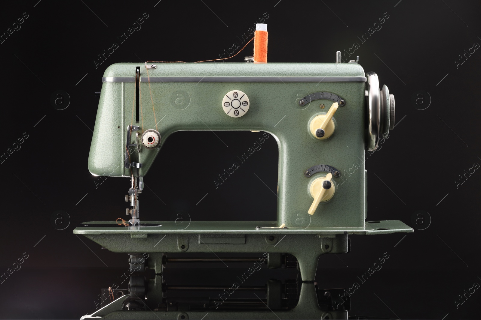 Photo of Vintage professional sewing machine on black background