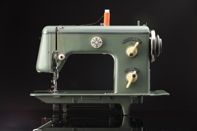 Photo of Vintage professional sewing machine on black background