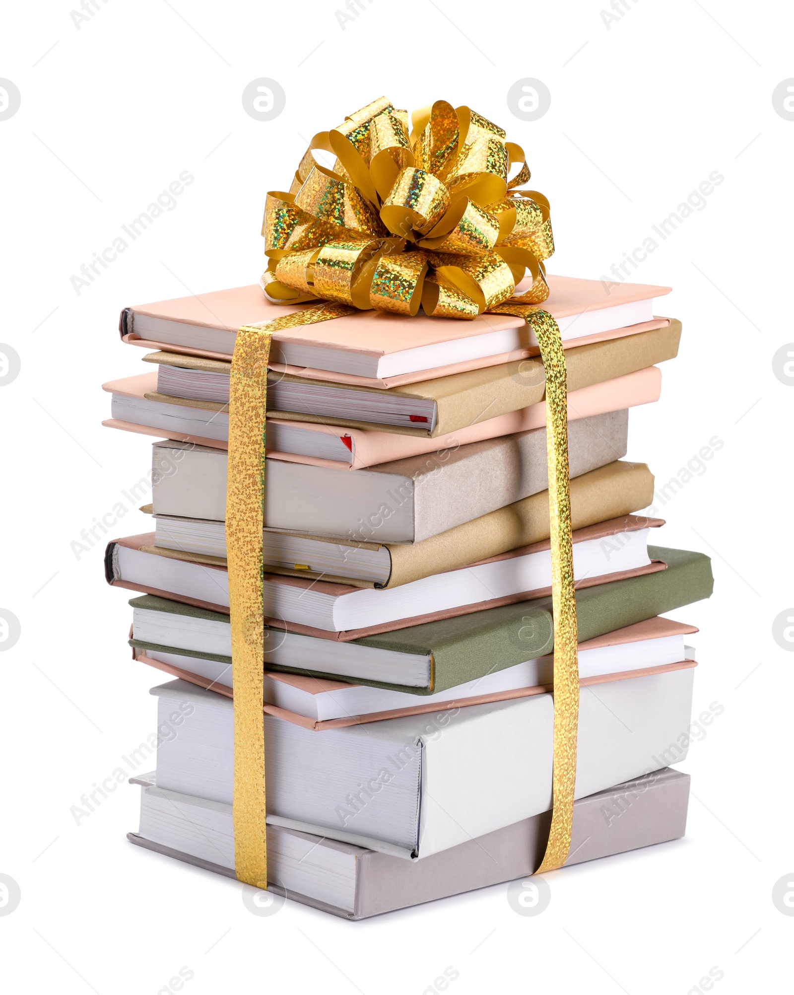 Photo of Stack of books with golden bow as gift isolated on white