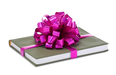 Photo of One book with purple bow as gift isolated on white