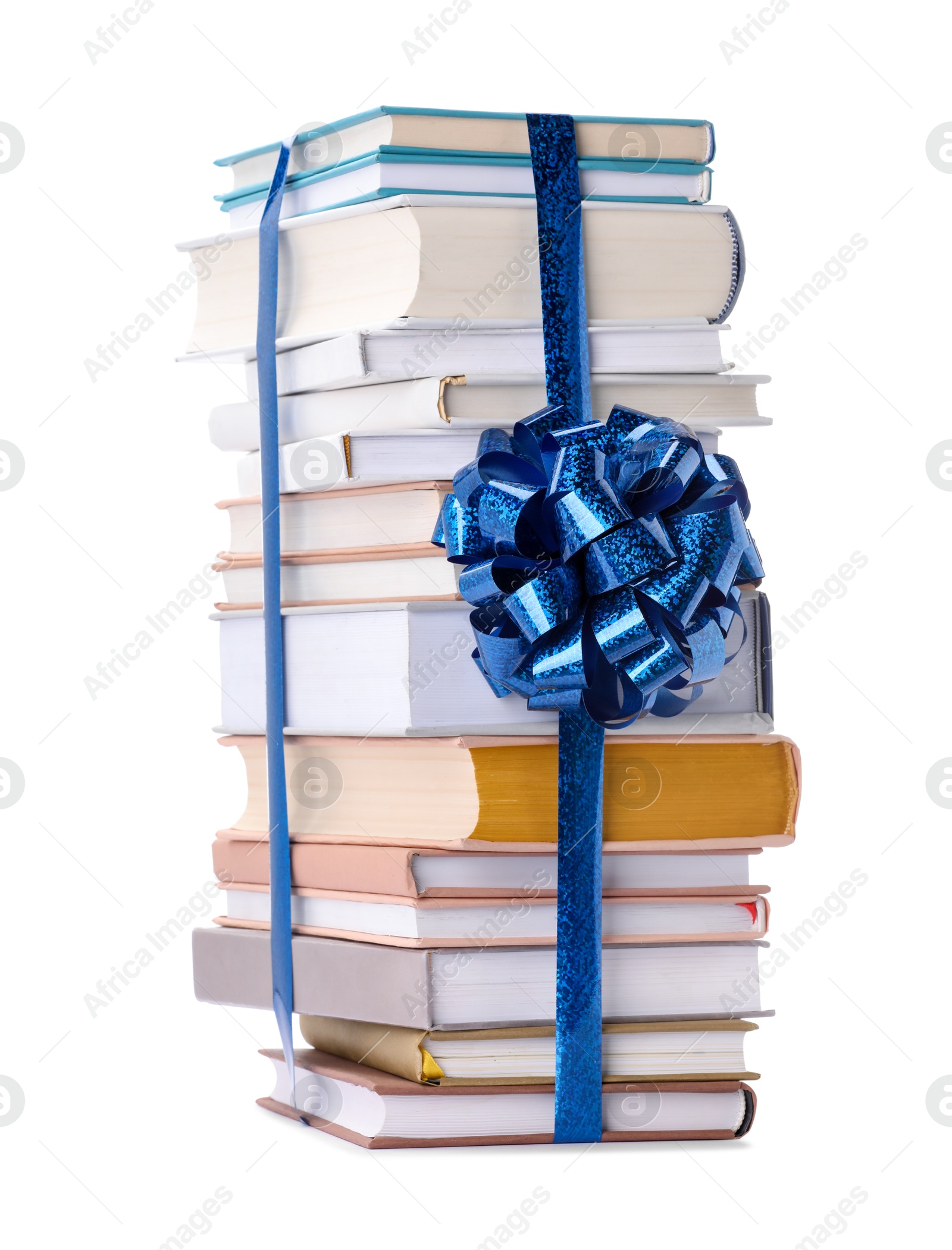 Photo of Stack of books with blue bow as gift isolated on white