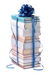 Photo of Stack of books with blue bow as gift isolated on white