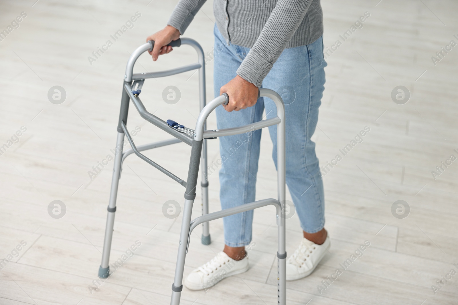 Photo of Senior woman with walking frame at home, closeup