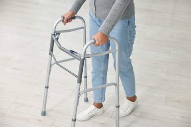 Photo of Senior woman with walking frame at home, closeup