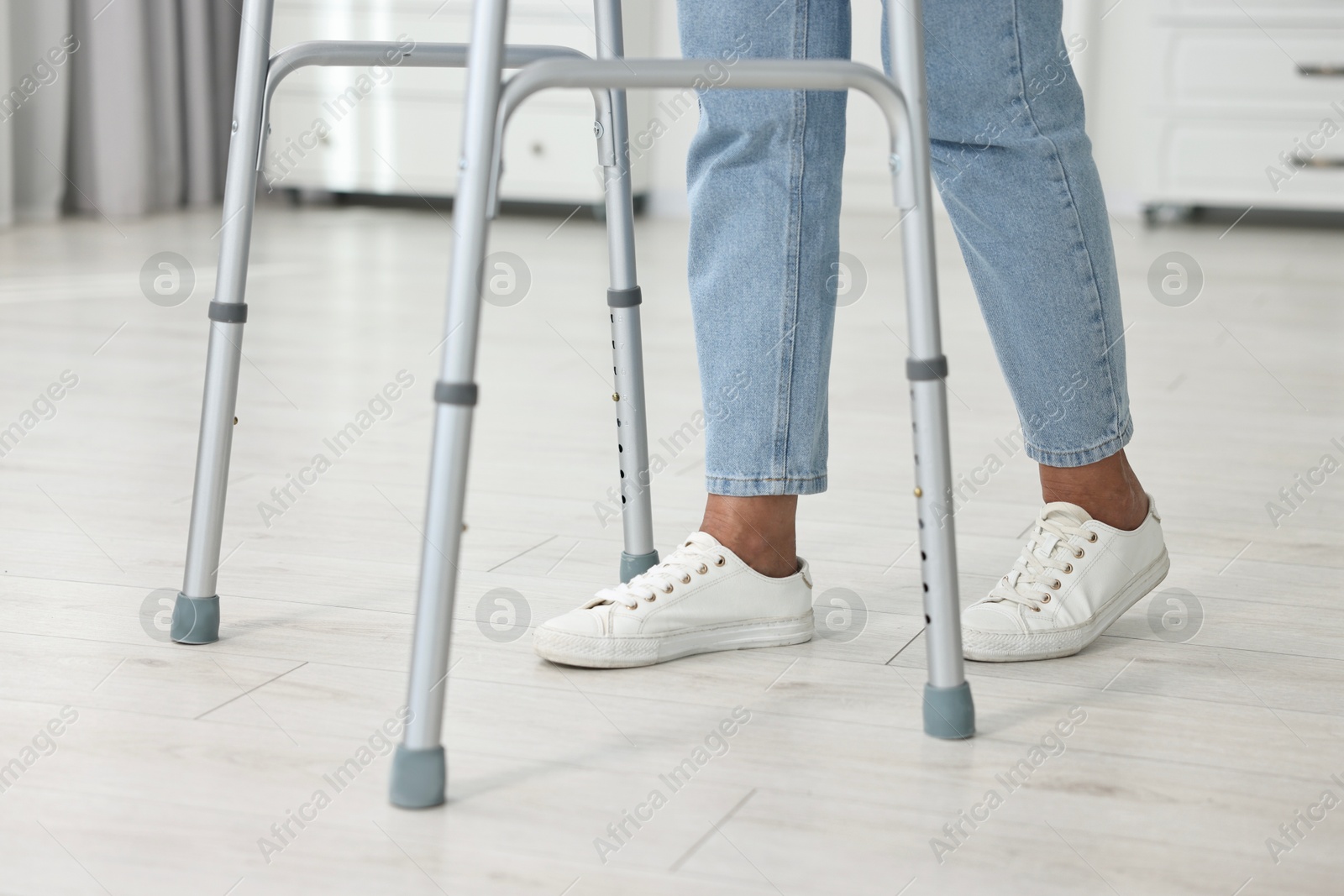 Photo of Senior woman with walking frame at home, closeup