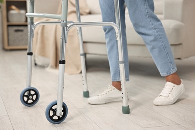 Photo of Senior woman with walking frame at home, closeup