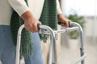 Photo of Senior woman with walking frame at home, closeup