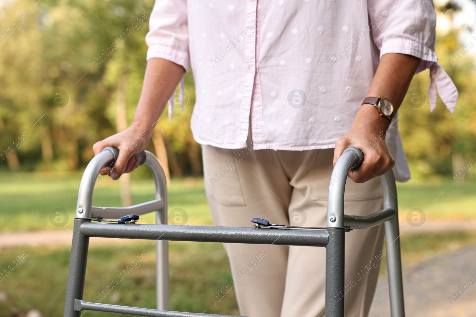 Photo of Senior woman with walking frame in park, closeup