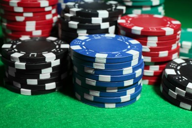 Photo of Poker game. Casino chips on green table, closeup