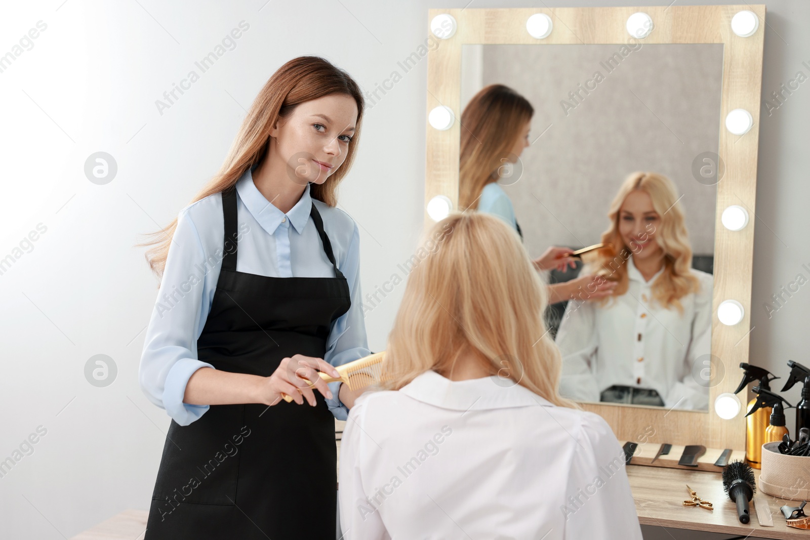 Photo of Hair cutting. Professional hairdresser working with client in salon