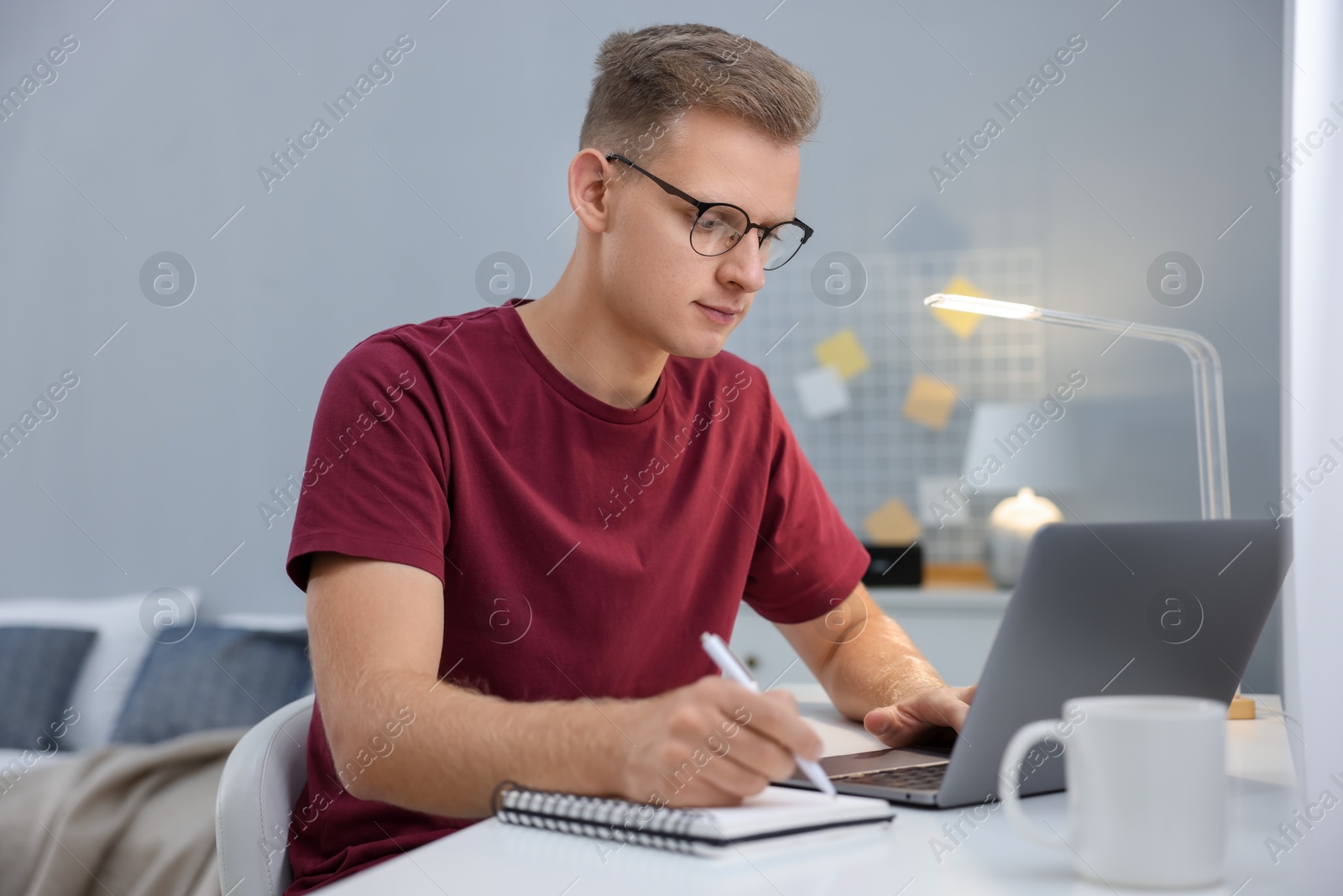 Photo of Student preparing for exam at table indoors