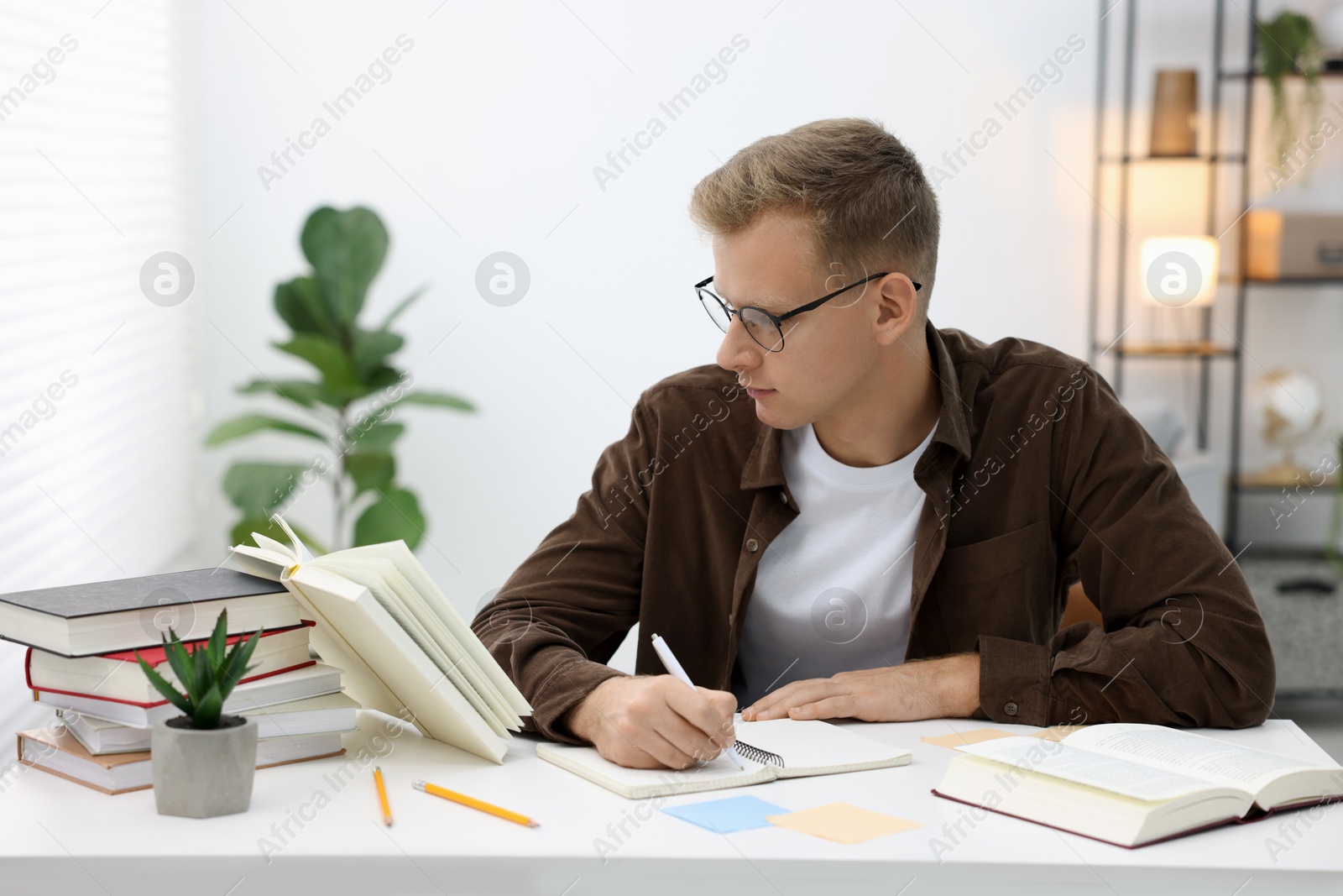 Photo of Student preparing for exam at table indoors