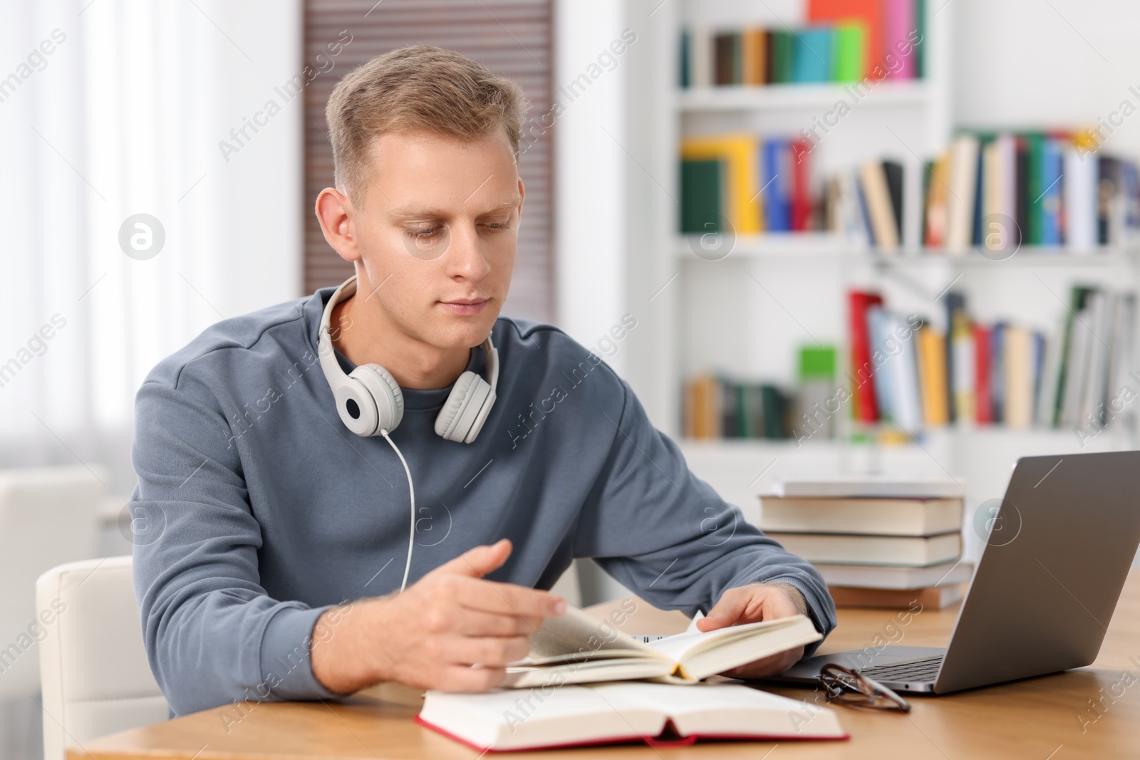 Photo of Student preparing for exam at table indoors