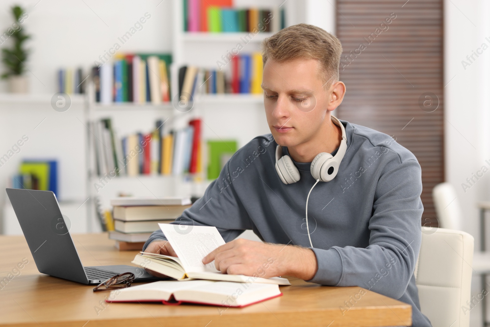 Photo of Student preparing for exam at table indoors