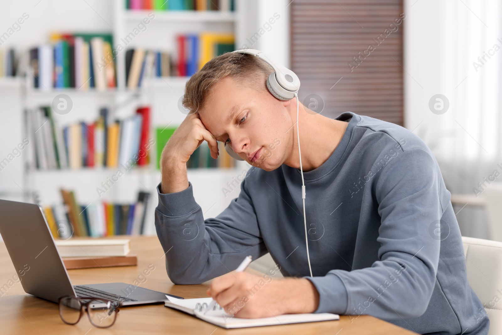 Photo of Student preparing for exam at table indoors