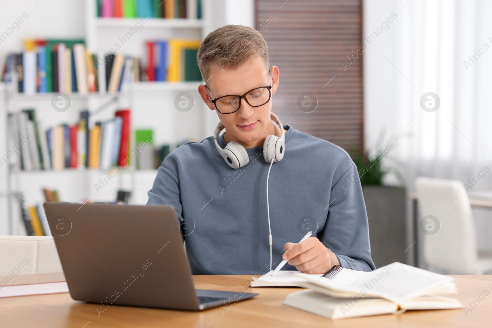 Photo of Student preparing for exam at table indoors