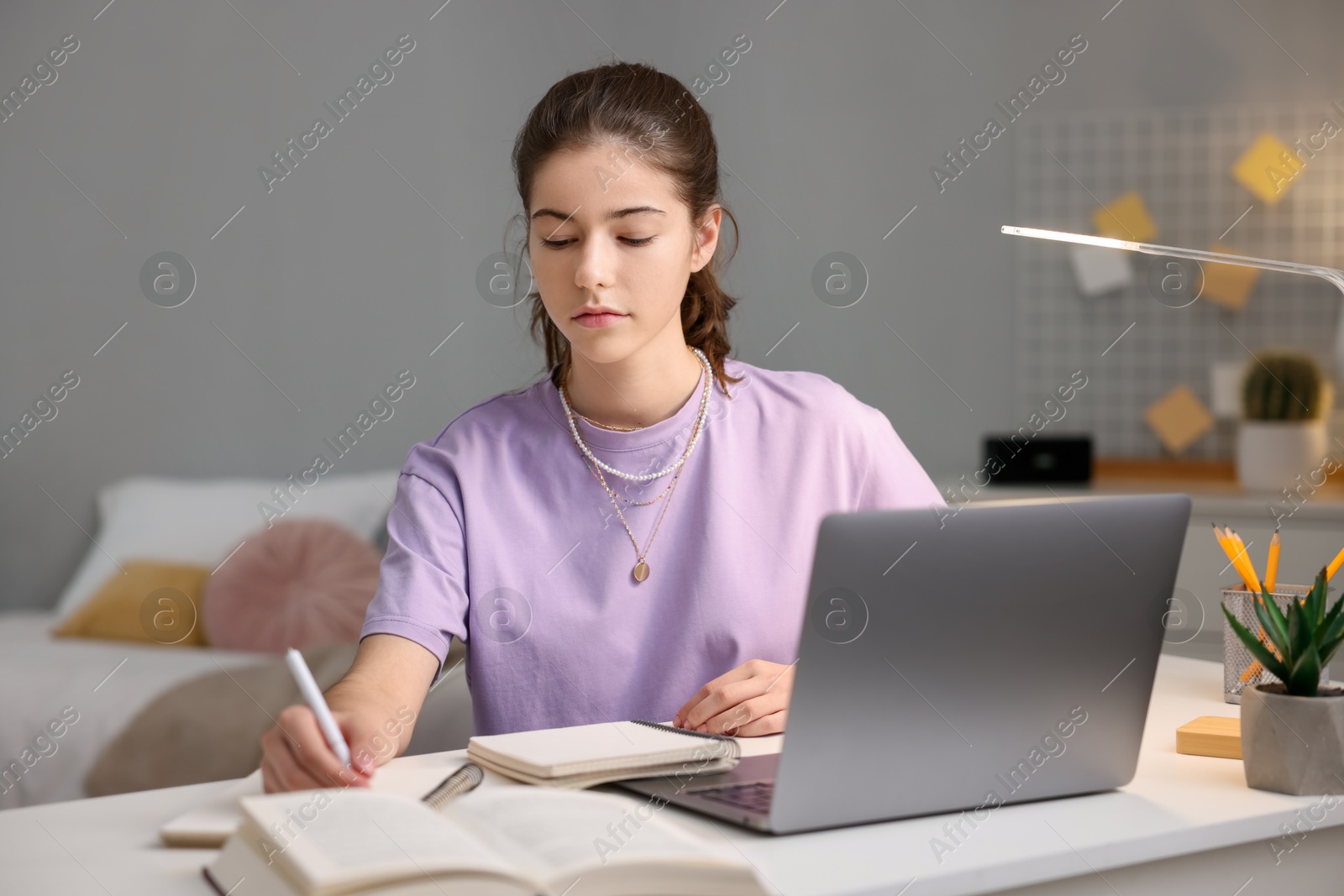 Photo of Student preparing for exam at table indoors