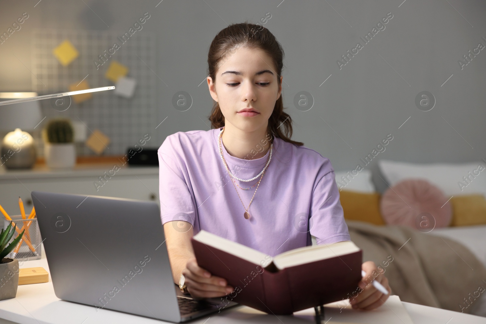 Photo of Student preparing for exam at table indoors