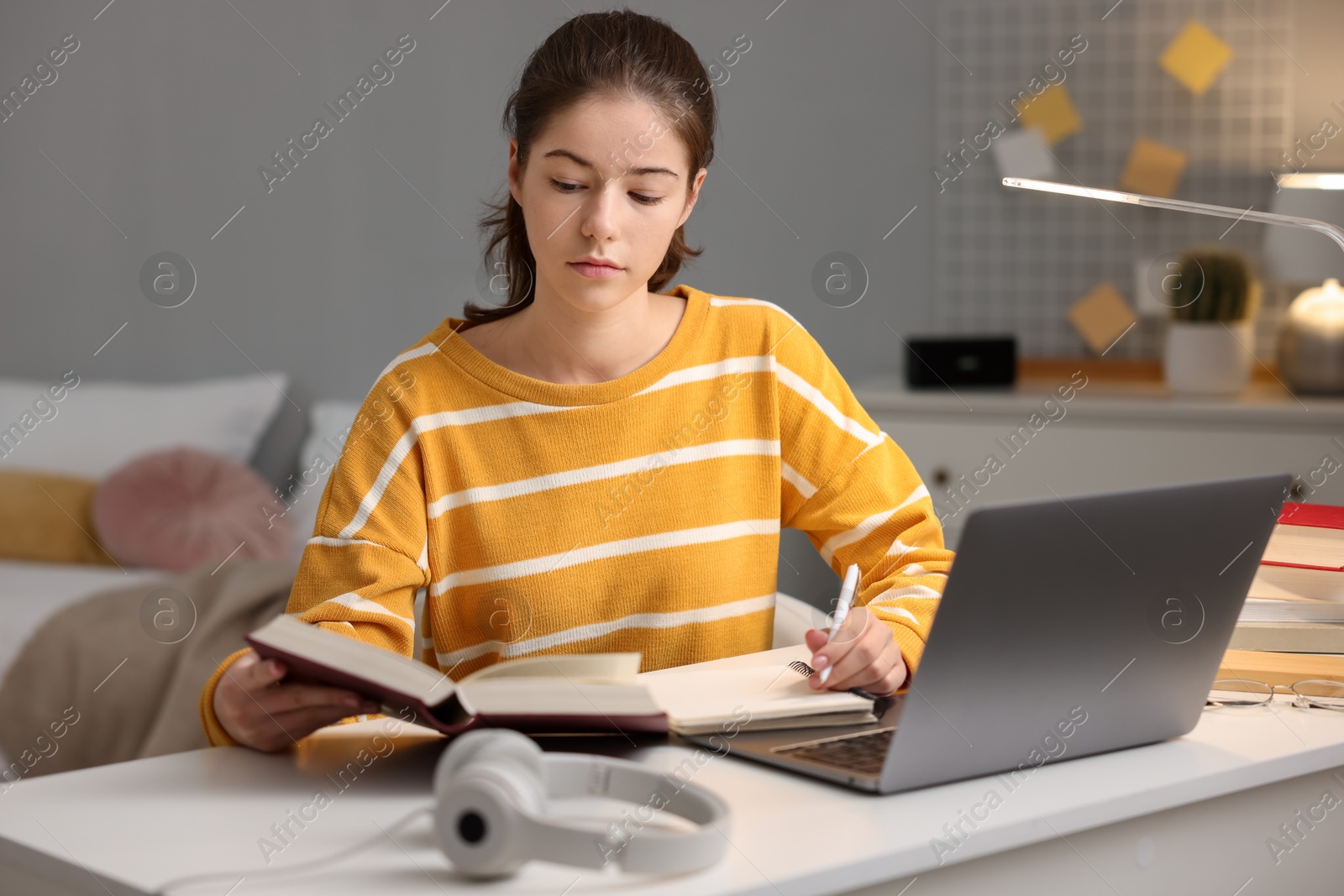 Photo of Student preparing for exam at table indoors