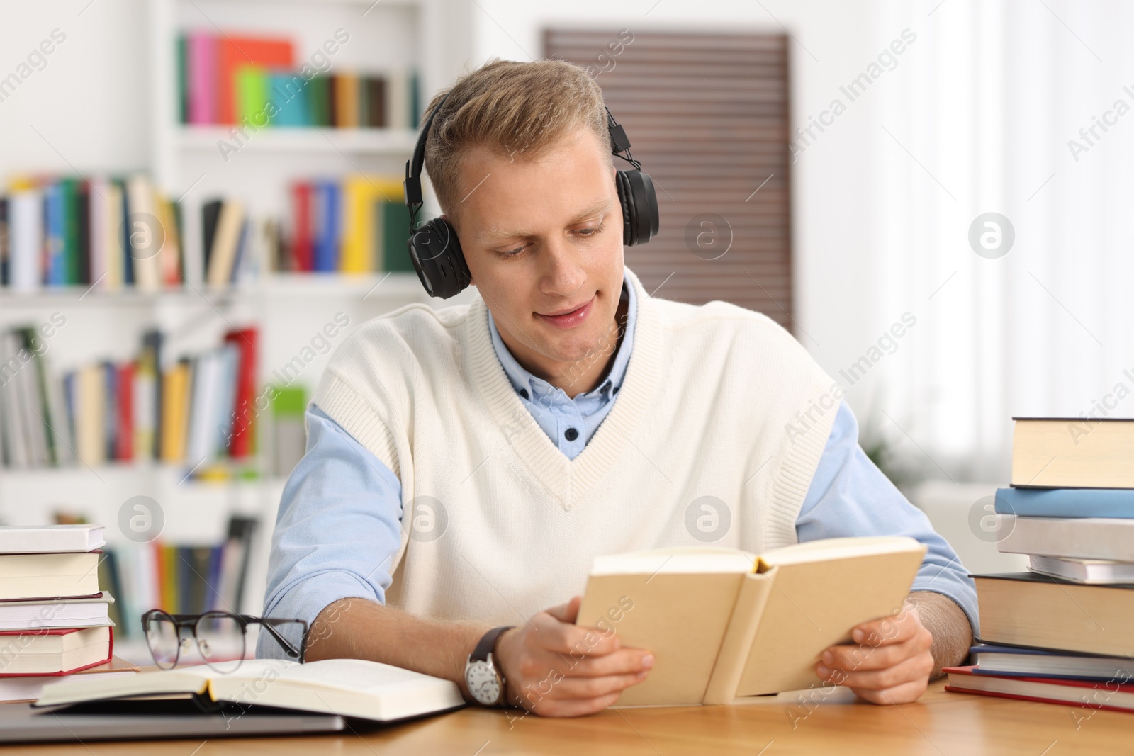 Photo of Student preparing for exam at table indoors