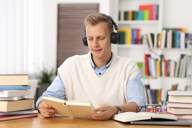 Photo of Student preparing for exam at table indoors