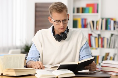 Photo of Student preparing for exam at table indoors