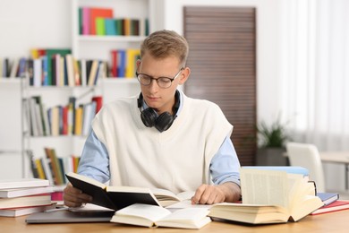 Photo of Student preparing for exam at table indoors