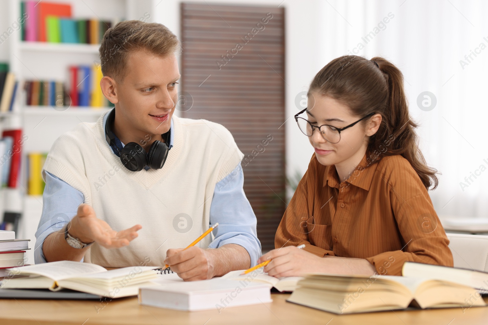 Photo of Students preparing for exam at table indoors