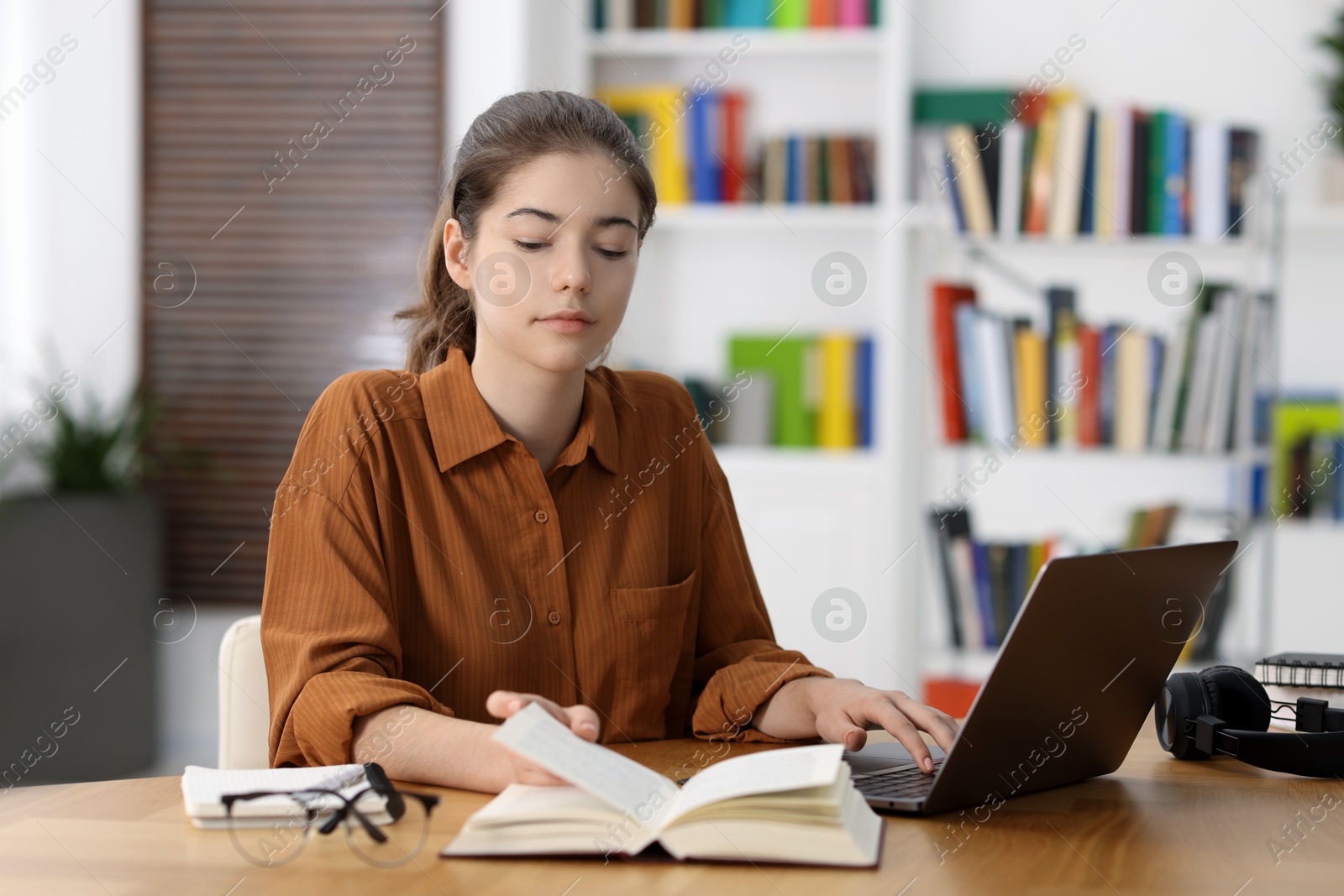 Photo of Student preparing for exam at table indoors