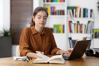 Photo of Student preparing for exam at table indoors