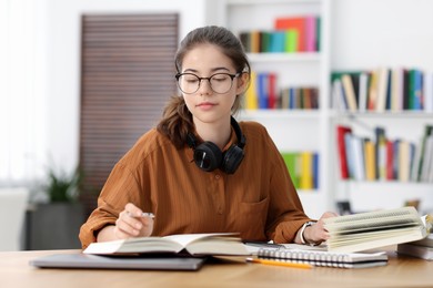 Photo of Student preparing for exam at table indoors