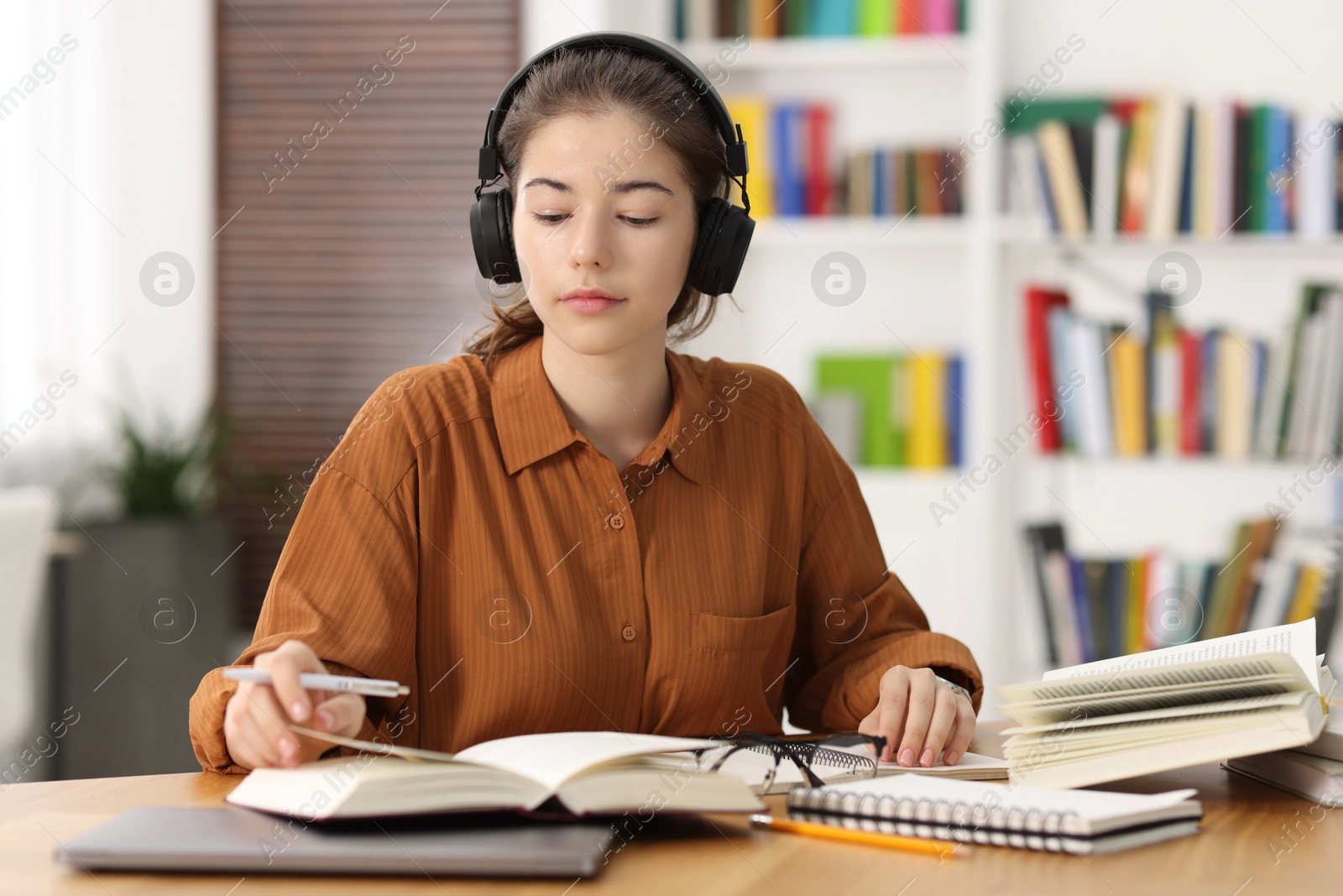 Photo of Student preparing for exam at table indoors