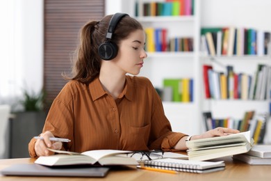 Photo of Student preparing for exam at table indoors