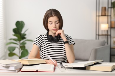 Photo of Student preparing for exam at table indoors