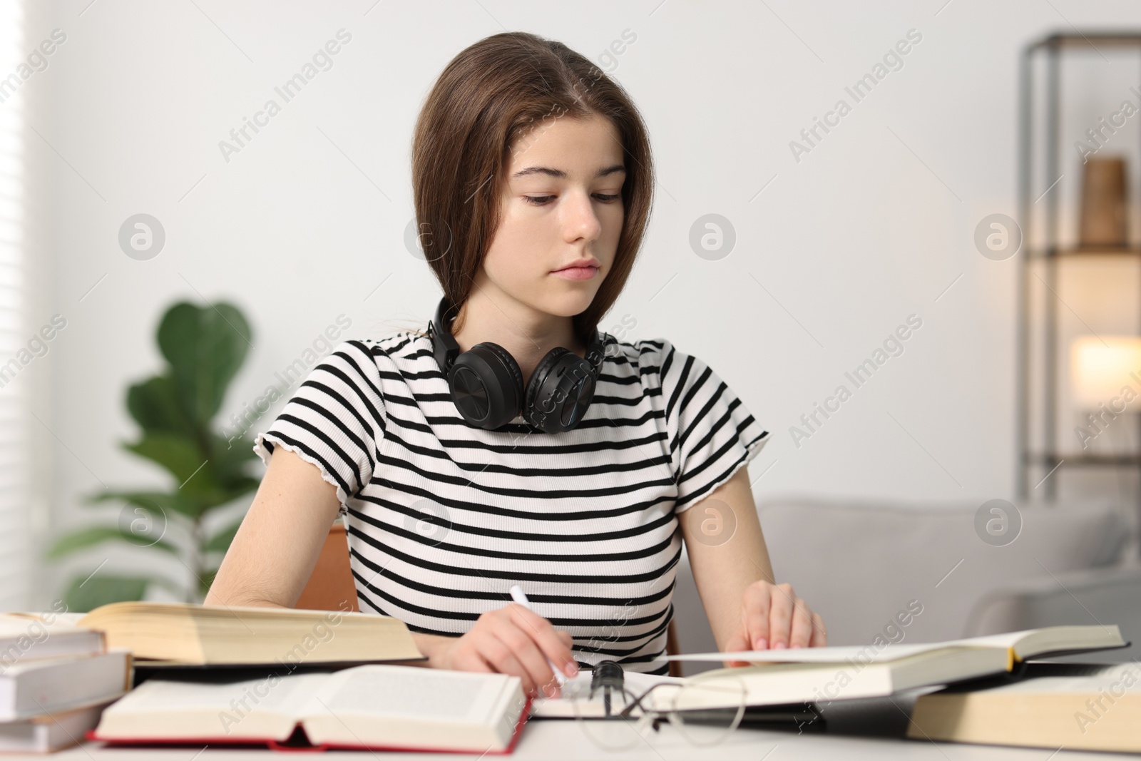 Photo of Student preparing for exam at table indoors