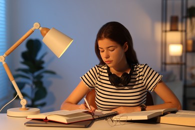 Student preparing for exam at table indoors