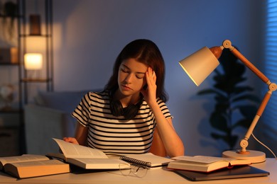 Photo of Student preparing for exam at table indoors